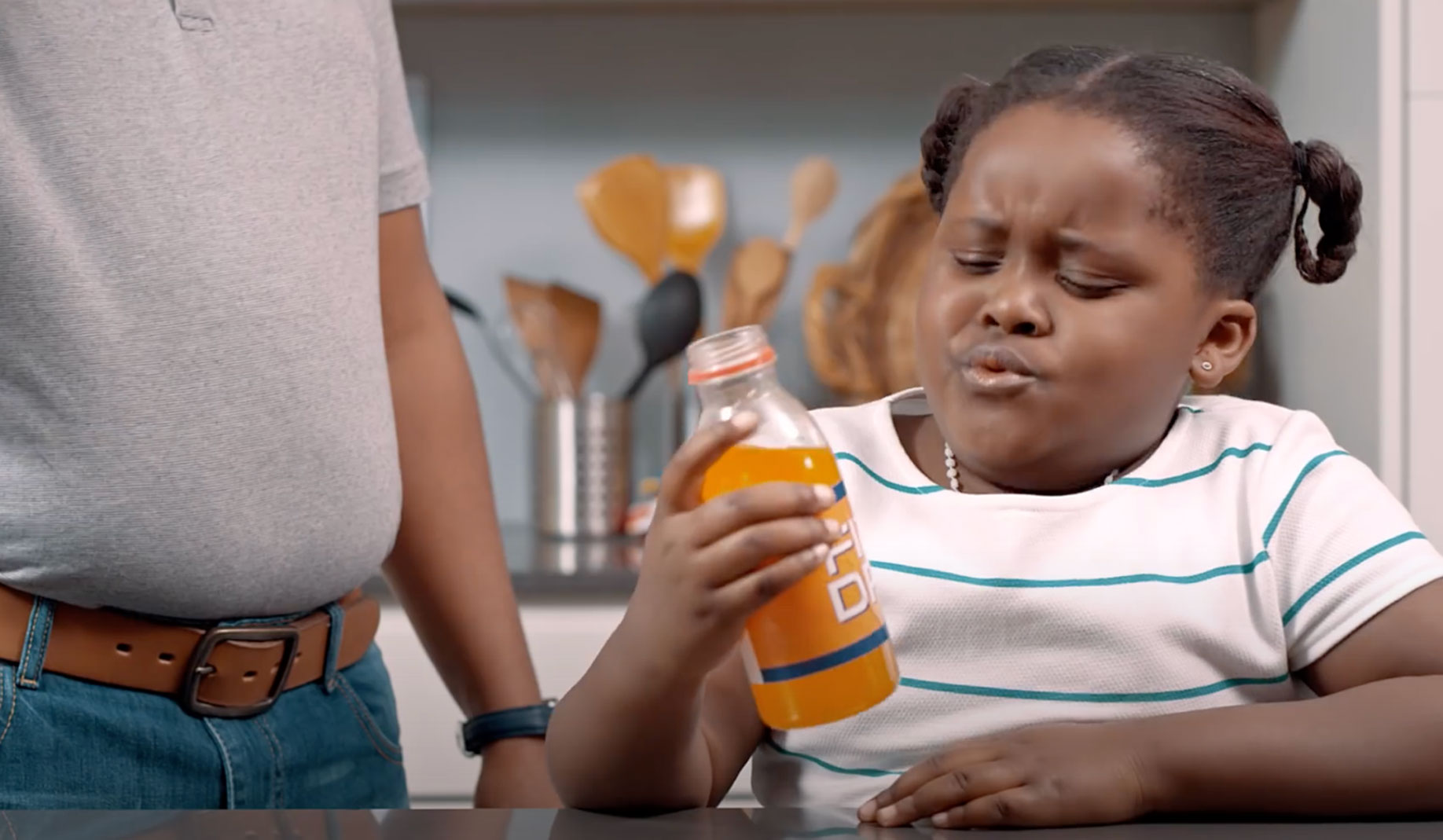 A still from “Are you drinking yourself sick?” agenda-setting TV ad featuring a child and her father, showing how drinking sugary drinks can lead to the onset of diseases Source: HEALA