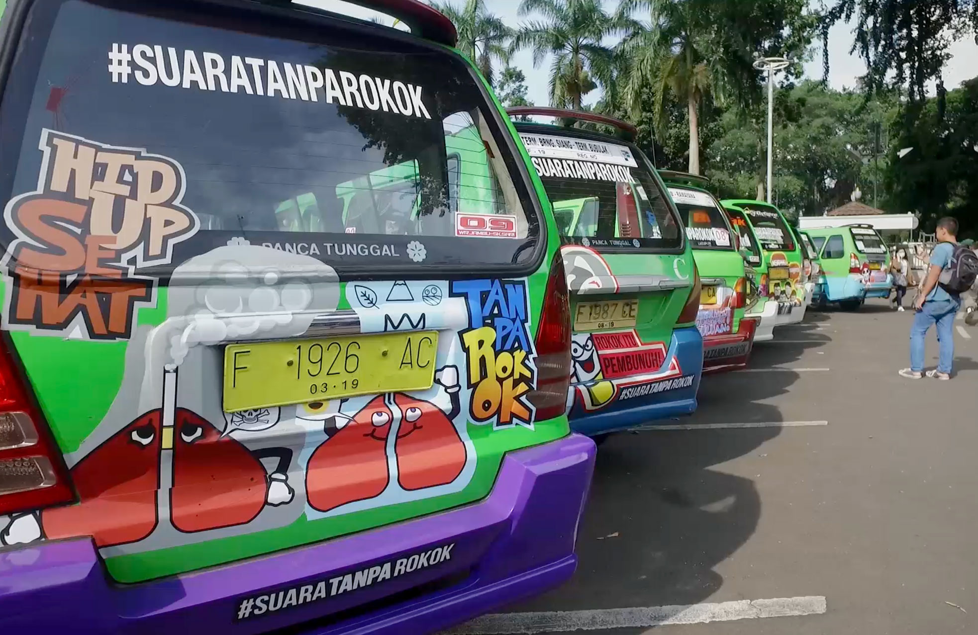 Health harm messages on minibuses in Bogor, Indonesia (World No Tobacco Day, 2017) as part of the #SuaraTanpaRokok (Voices Without Cigarettes) campaign to enforce smoke free public transportation.